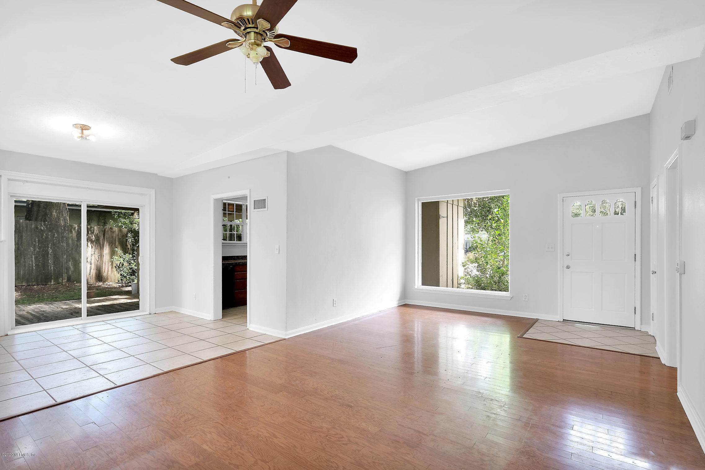 1242 Morgana Road Jacksonville, FL 32211 - Photo 8 of 26 a view of an empty room with window and wooden floor