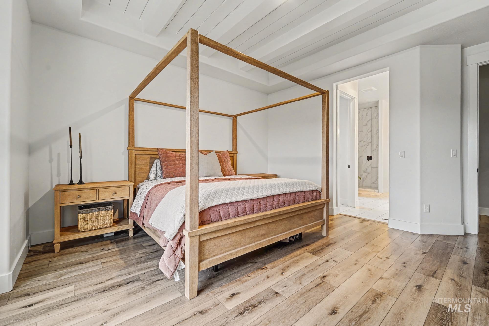 18357 North Burnt Car Way Boise, ID 83714 - Photo 21 of 48 Bedroom featuring light wood finished floors and ensuite bathroom