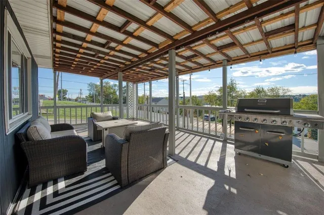 a view of a living room with furniture wooden floor and flat screen tv