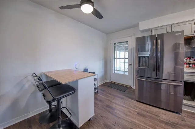 a kitchen with stainless steel appliances granite countertop a refrigerator a stove a sink and a microwave