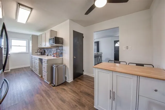 a room with kitchen island a sink a stove and a refrigerator