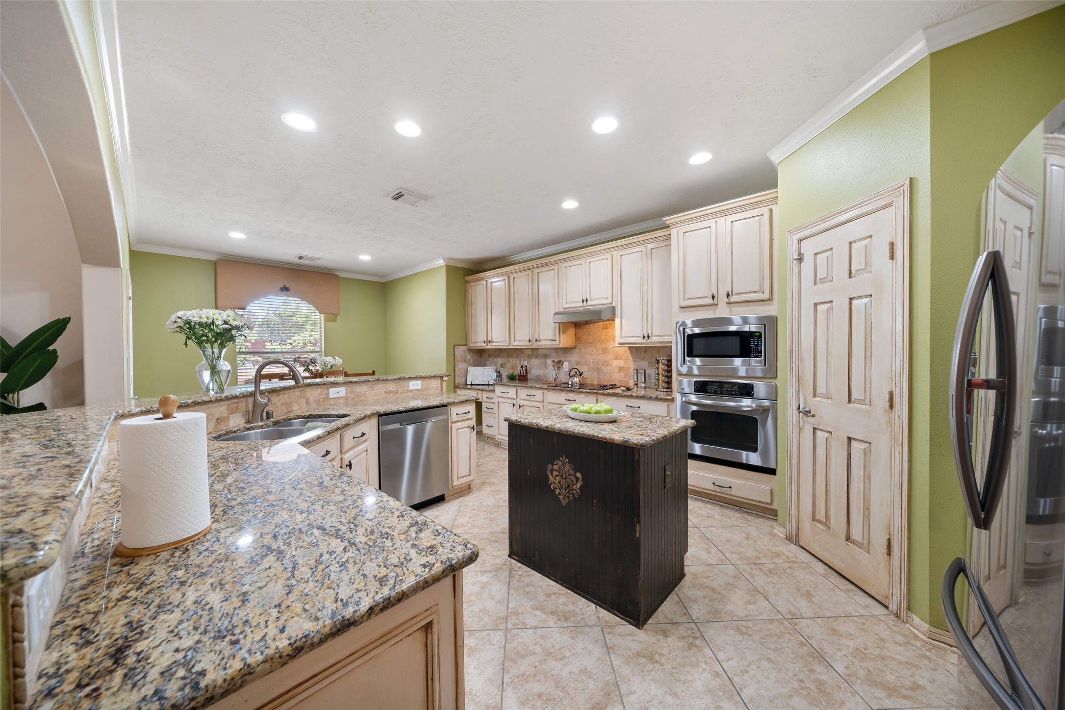6407 Ashley Manor Drive Spring, TX 77389 - Photo 12 of 41 a kitchen with stainless steel appliances granite countertop a sink a stove and a refrigerator
