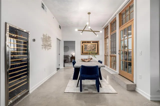 a spacious bedroom with a bed and wooden floor