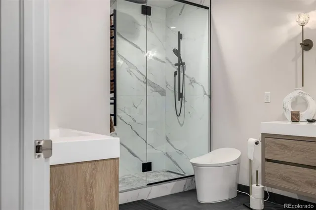 a roof deck with couches and potted plants