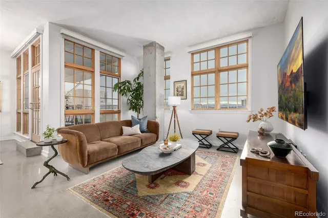 a living room with furniture fireplace and a flat screen tv