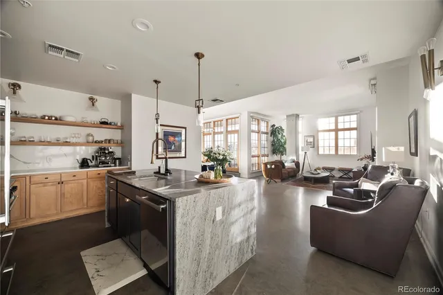 a kitchen with stainless steel appliances granite countertop a sink and wooden cabinets