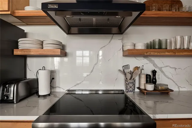 a view of living room with furniture and large windows