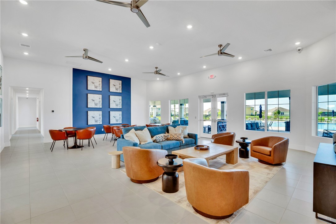3453 Trinity Circle Fort Pierce, FL 34945 - Photo 29 of 36 a living room with furniture and a chandelier