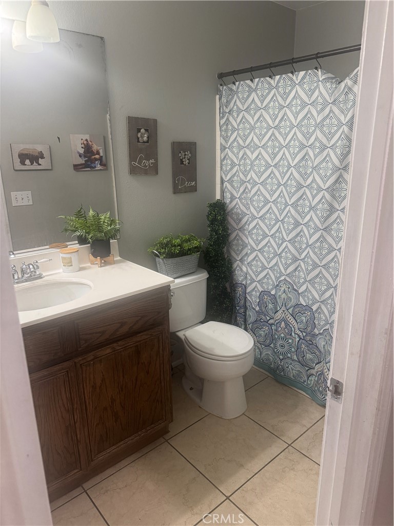 4300 Cloudywing Road Hemet, CA 92545 - Photo 13 of 29 a bathroom with a toilet a sink and a shower