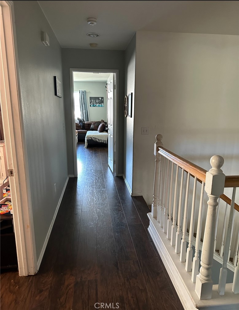 4300 Cloudywing Road Hemet, CA 92545 - Photo 17 of 29 a view of a hallway to a livingroom with wooden floor and furniture