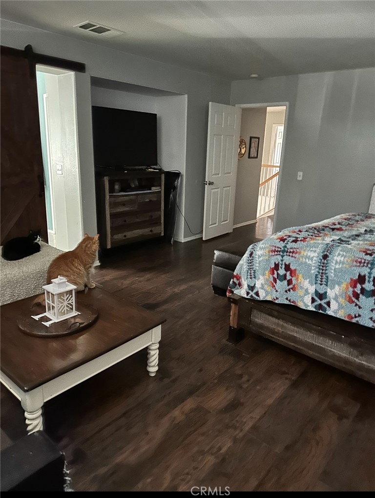 4300 Cloudywing Road Hemet, CA 92545 - Photo 18 of 29 a bed room with a bed window and a flat screen tv