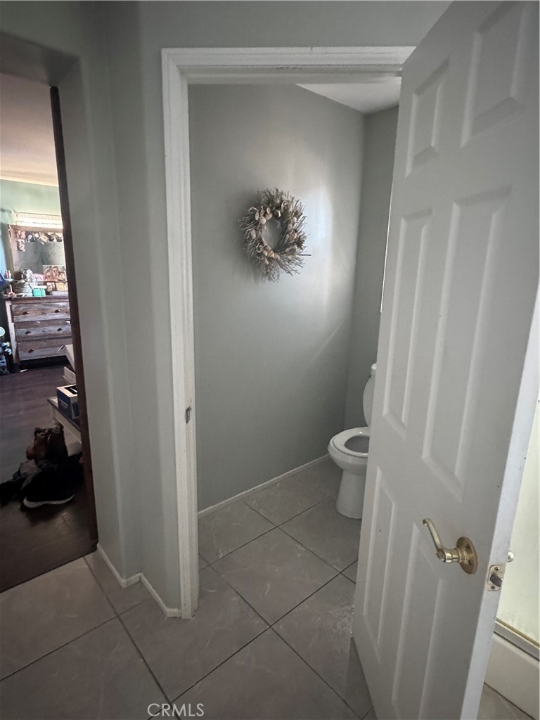 4300 Cloudywing Road Hemet, CA 92545 - Photo 22 of 29 a bathroom with a toilet and a shower curtain