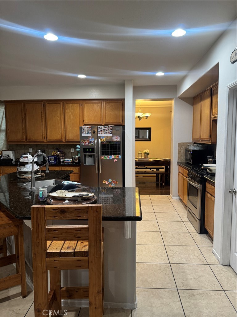 4300 Cloudywing Road Hemet, CA 92545 - Photo 8 of 29 a kitchen with stainless steel appliances granite countertop a stove a sink and a refrigerator