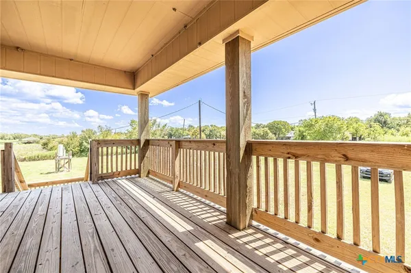 a view of a balcony with wooden floor