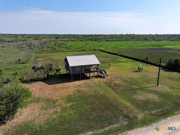 a view of a lake with a yard