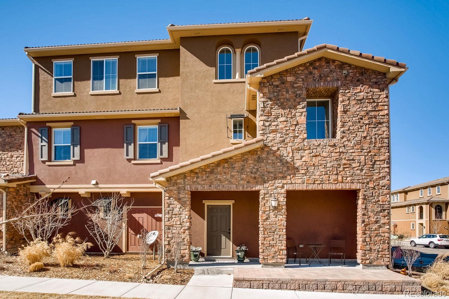 9511 Loggia Street, Unit C Highlands Ranch, CO 80126 - Photo 1 of 32 a front view of a house with garden