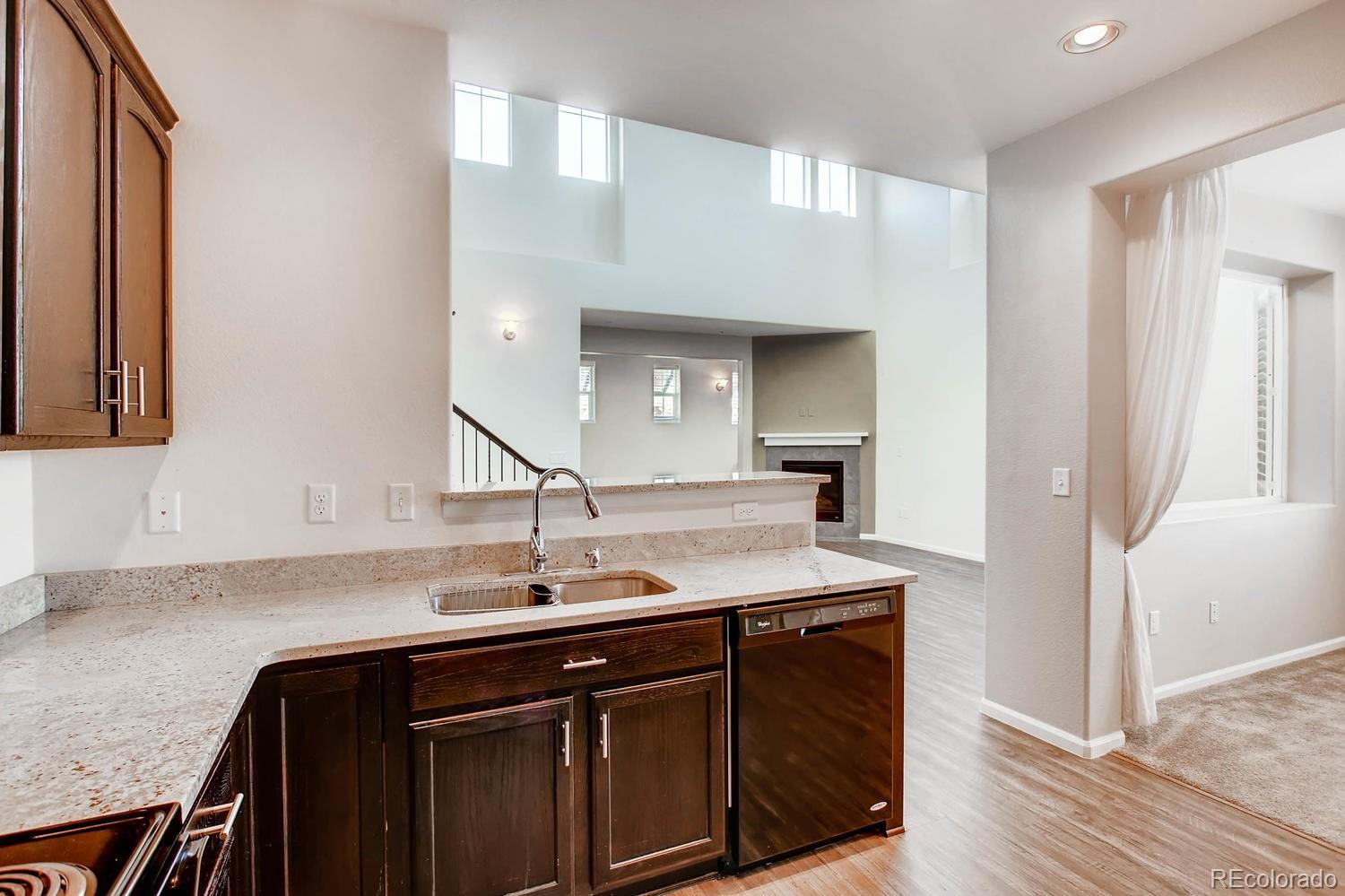9511 Loggia Street, Unit C Highlands Ranch, CO 80126 - Photo 12 of 32 a kitchen with a sink cabinets and a wooden floor