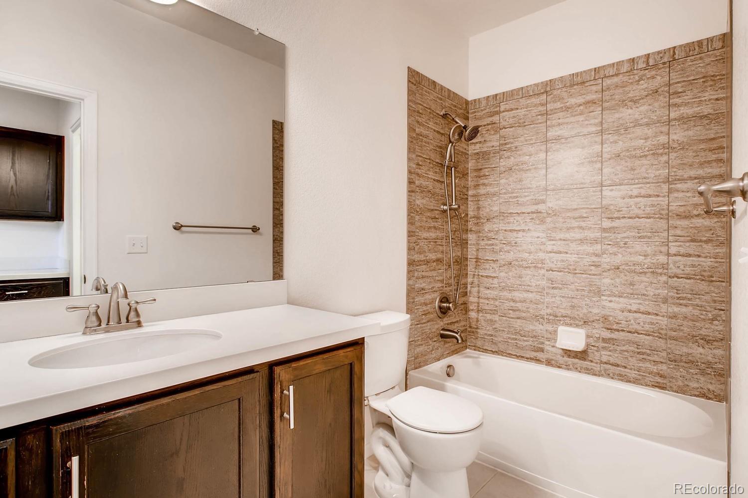 9511 Loggia Street, Unit C Highlands Ranch, CO 80126 - Photo 17 of 32 a bathroom with a sink a toilet and shower