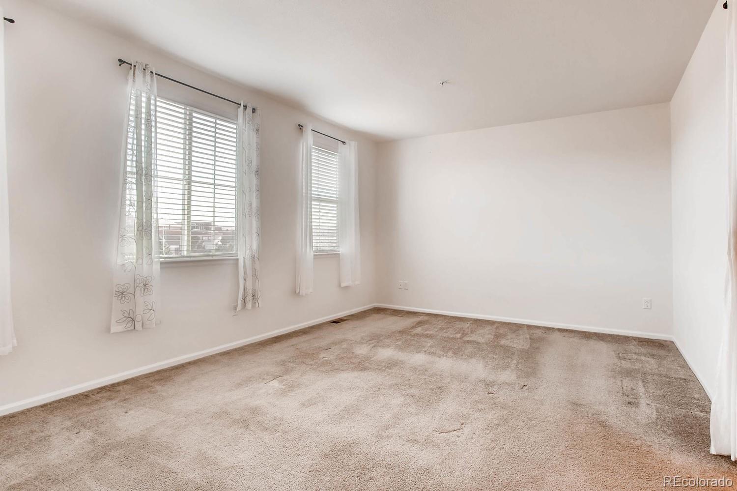 9511 Loggia Street, Unit C Highlands Ranch, CO 80126 - Photo 18 of 32 an empty room with windows