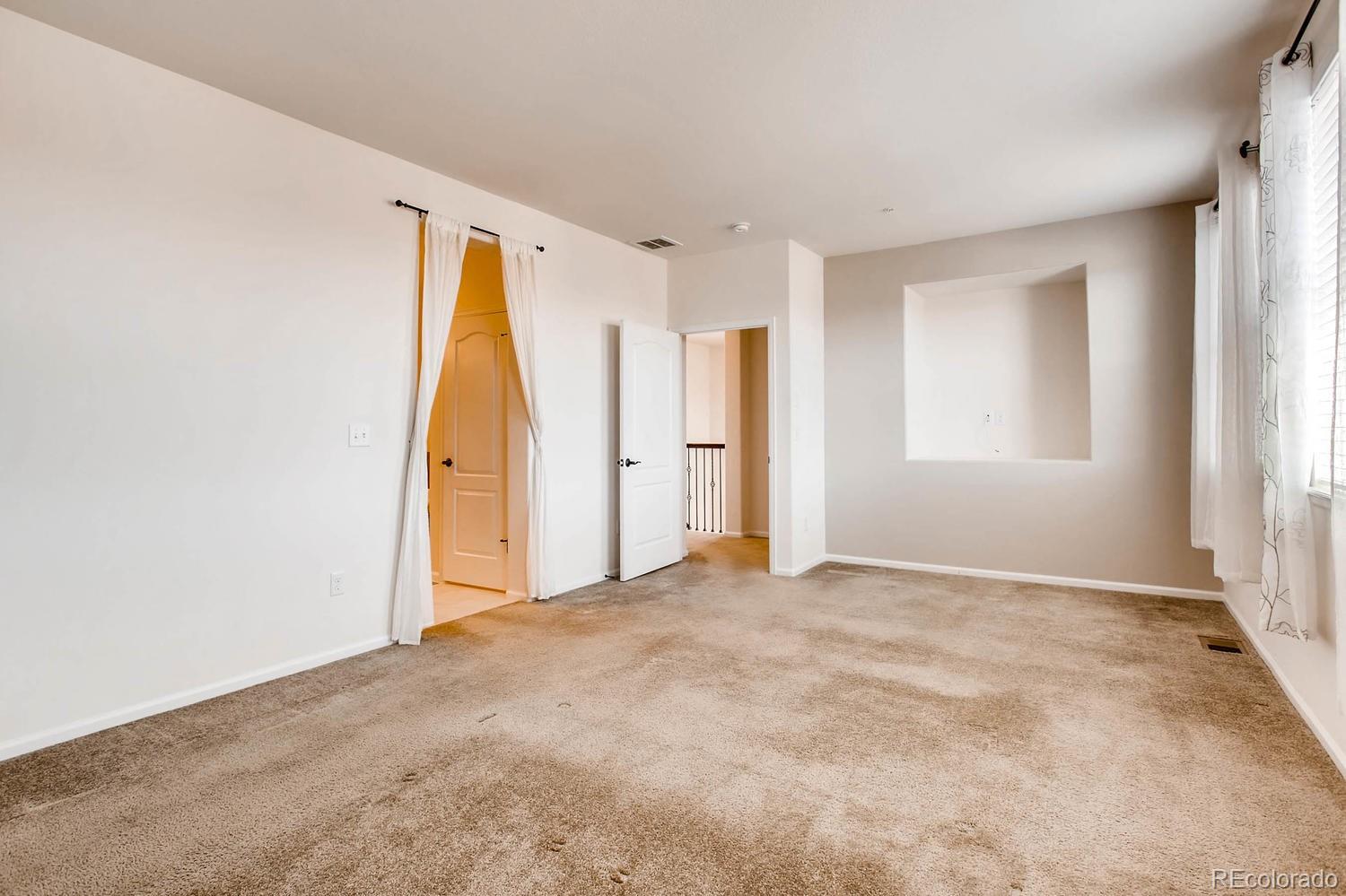 9511 Loggia Street, Unit C Highlands Ranch, CO 80126 - Photo 20 of 32 a view of an empty room with a window