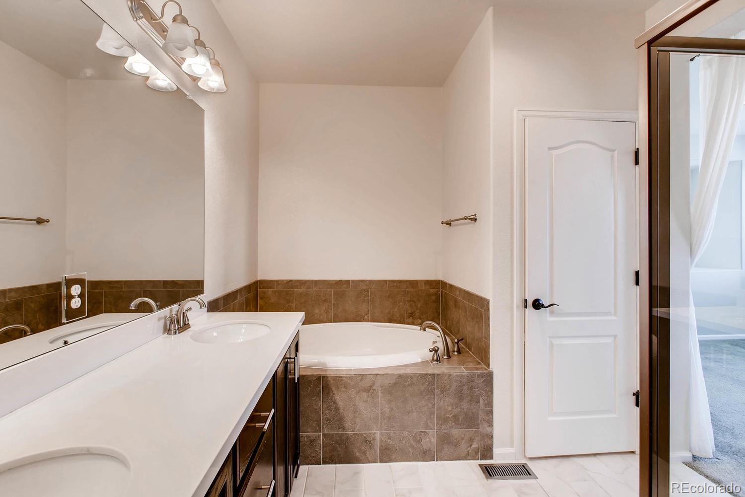 9511 Loggia Street, Unit C Highlands Ranch, CO 80126 - Photo 21 of 32 a bathroom with a sink and a mirror