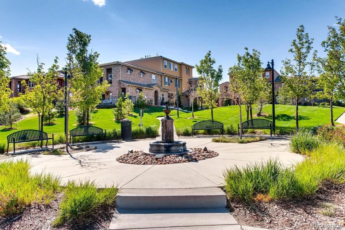 9511 Loggia Street, Unit C Highlands Ranch, CO 80126 - Photo 29 of 32 a view of a building with a garden and pathway
