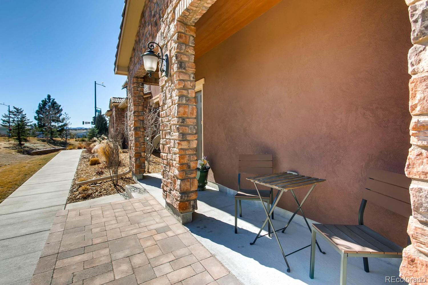 9511 Loggia Street, Unit C Highlands Ranch, CO 80126 - Photo 3 of 32 a view of a patio with a table and chairs