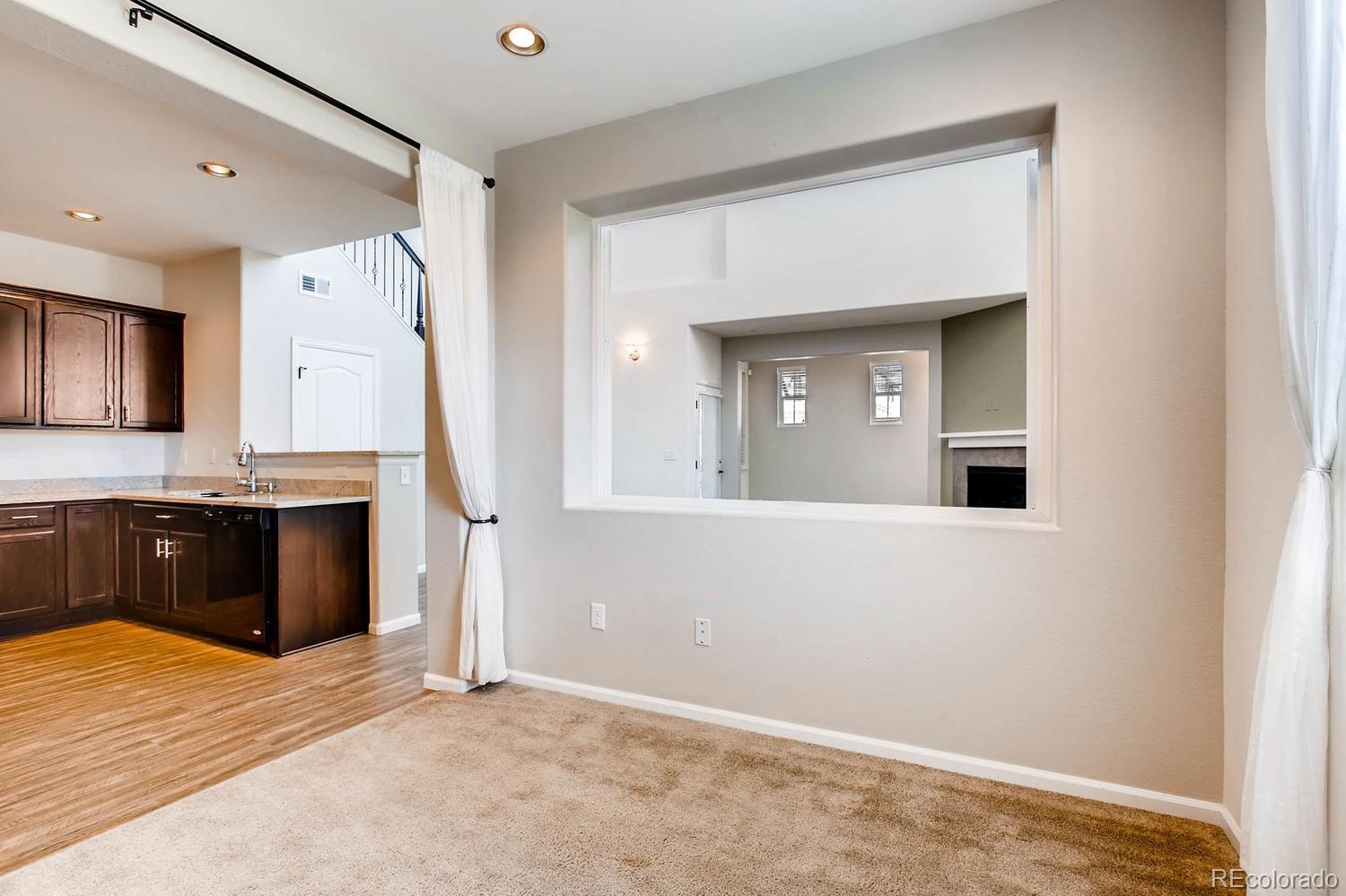 9511 Loggia Street, Unit C Highlands Ranch, CO 80126 - Photo 9 of 32 a view of a kitchen with a sink and a refrigerator