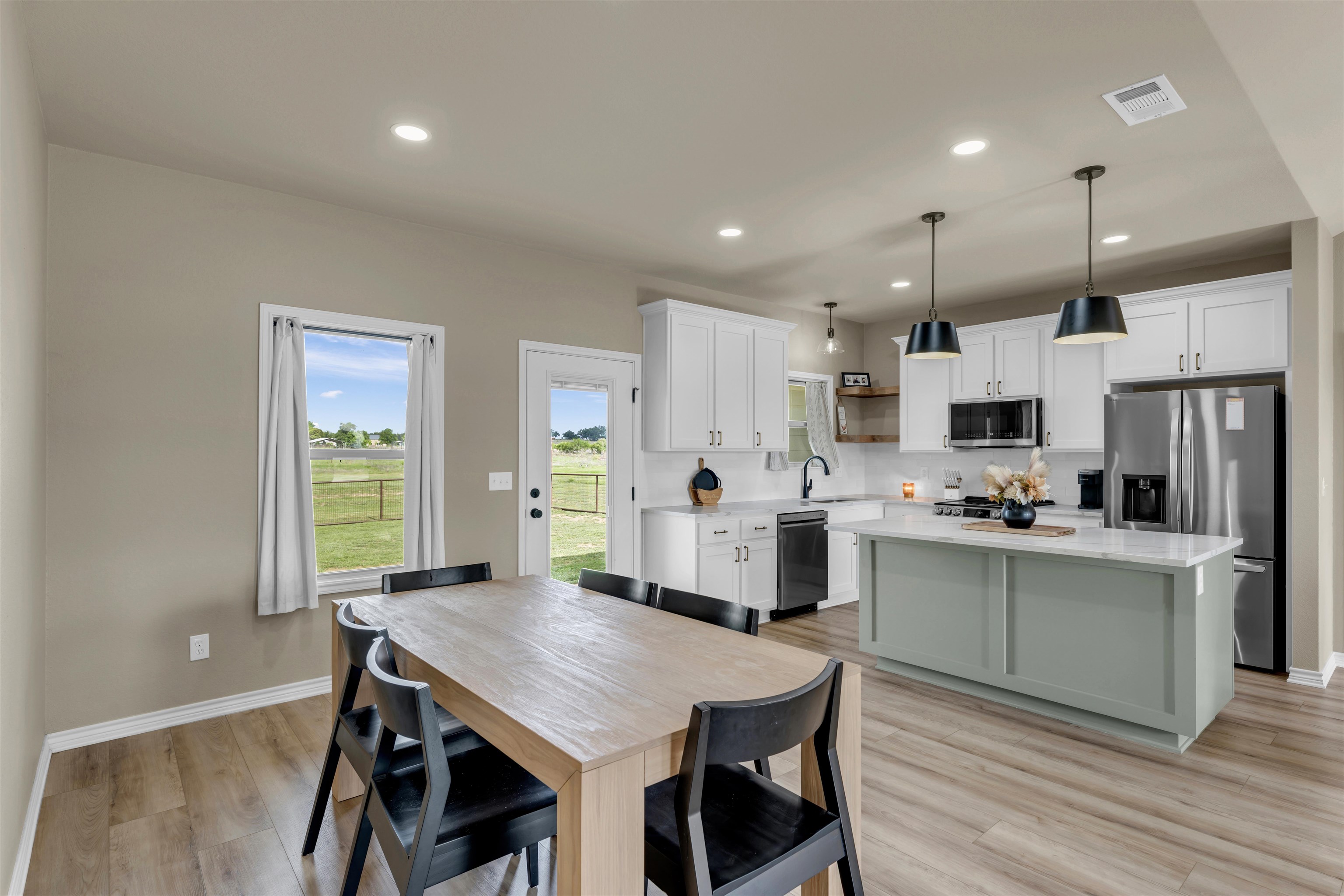 494 Johnson Road Mason, TX 76856 - Photo 7 of 28 a kitchen with stainless steel appliances kitchen island granite countertop a table chairs and a refrigerator