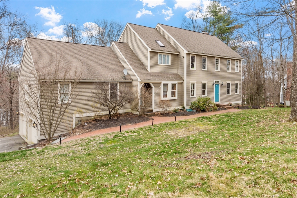 a backyard of a house with table and chairs