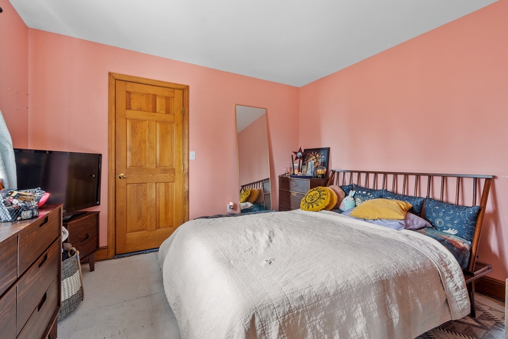 76 Woobly Road Bolton, MA 01740 - Photo 24 of 27 a bedroom with a bed and a flat tv screen on dresser