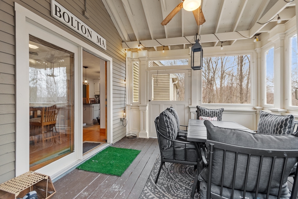 76 Woobly Road Bolton, MA 01740 - Photo 25 of 27 a living room with furniture and a floor to ceiling window
