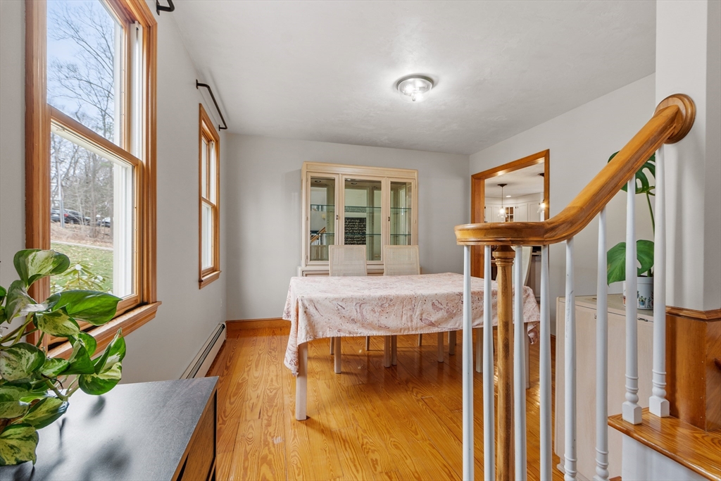 76 Woobly Road Bolton, MA 01740 - Photo 4 of 27 a bath room with a table chairs and a potted plant
