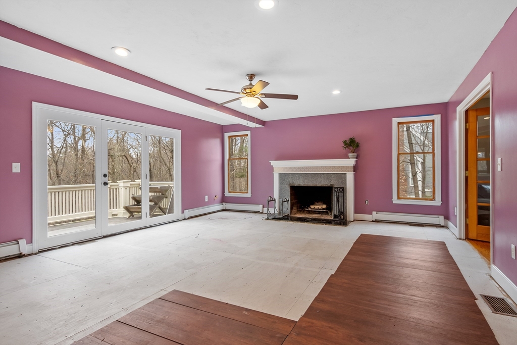 76 Woobly Road Bolton, MA 01740 - Photo 9 of 27 a view of an empty room with a fireplace and a window