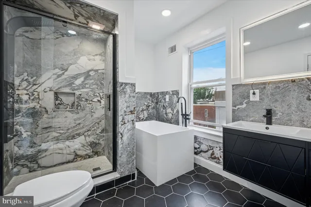 a bathroom with a toilet and a shower