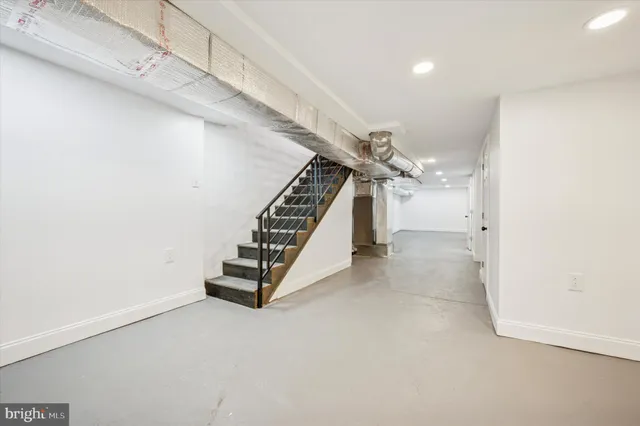 a view of terrace with lawn chairs and iron fence