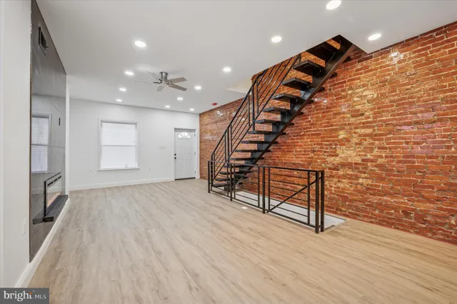 a view of entryway with wooden floor and stairs