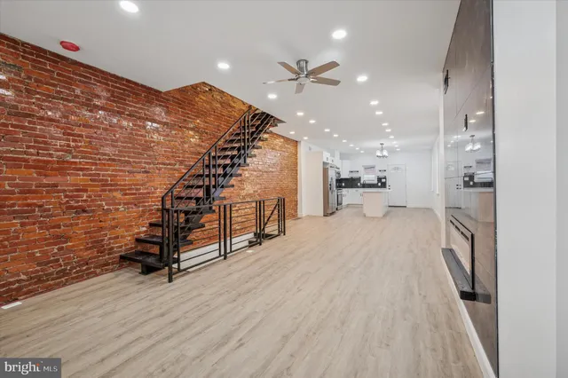 a view of a hallway with wooden floor and staircase