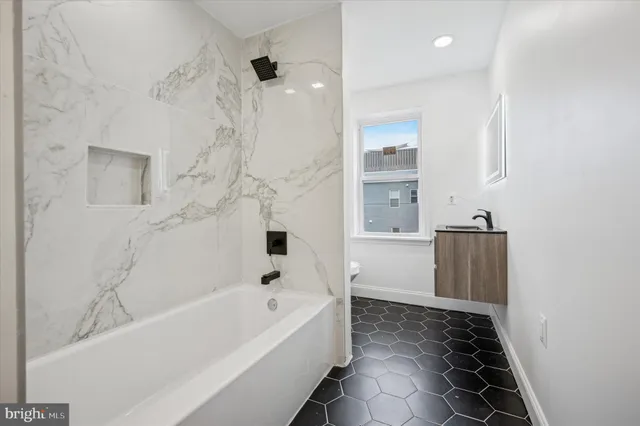 a bathroom with a bathtub and a shower