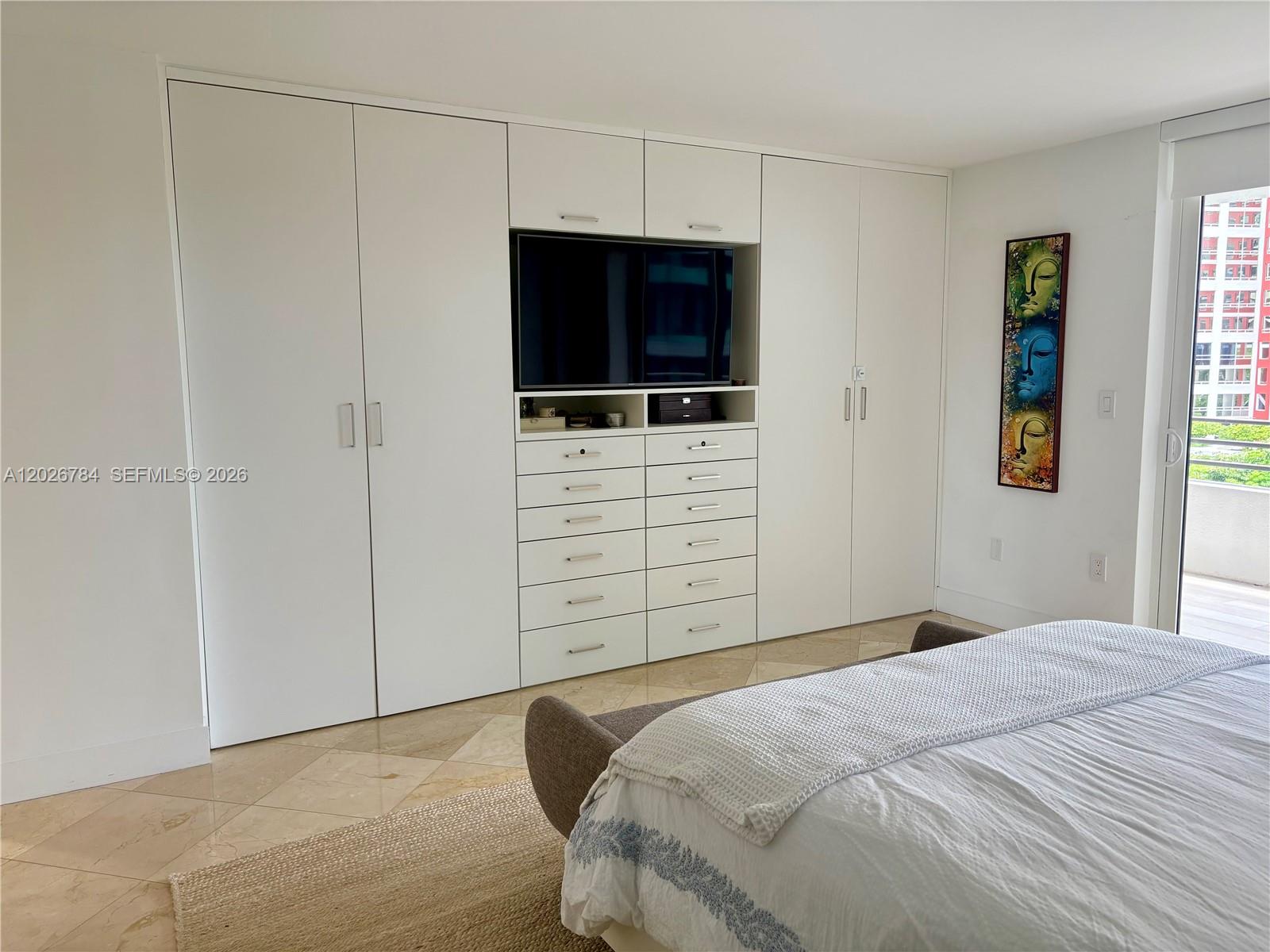 151 Southeast 15th Road, Unit 601 Miami, FL 33129 - Photo 20 of 36 a bedroom with a bed and a flat screen tv
