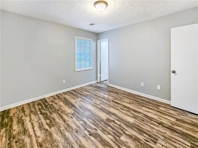 a view of a room with wooden floor and windows