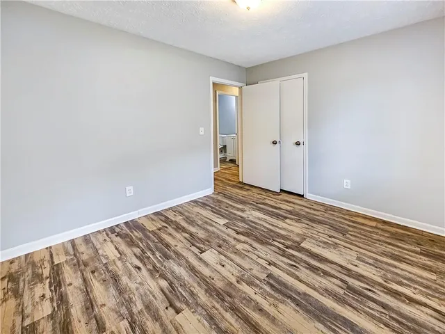 a view of a room with wooden floor and white walls