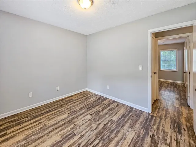 a view of a room with wooden floor