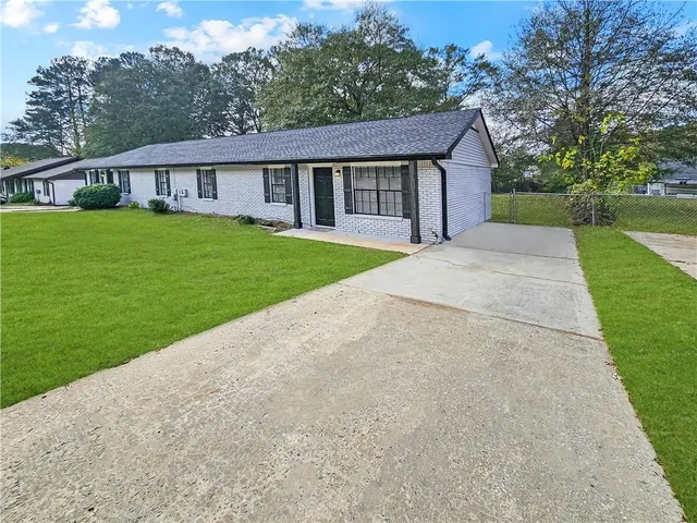 a view of house that has a yard