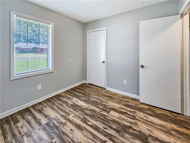 a view of a room with wooden floor and windows