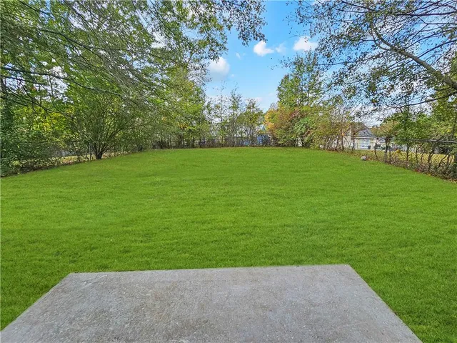 a view of a grassy field with trees