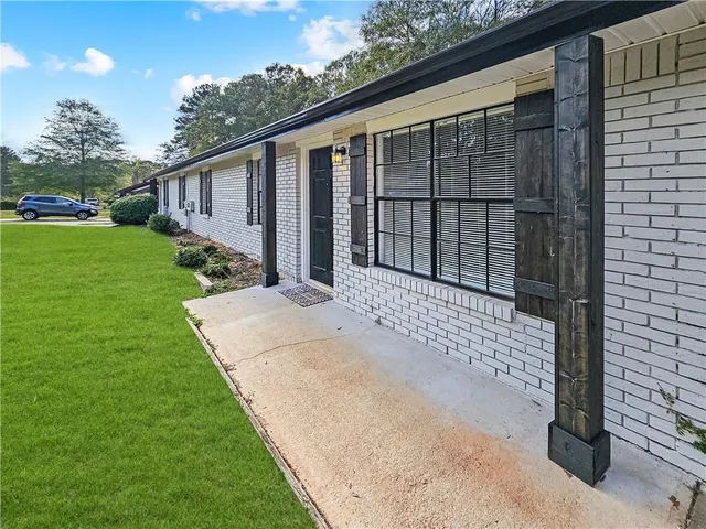 a front view of a house with a garden