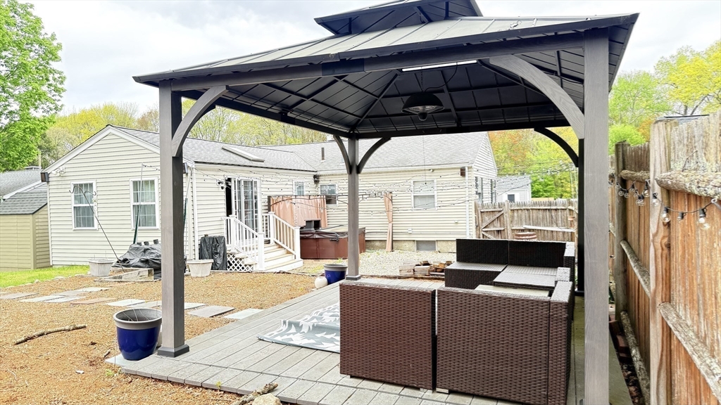 118 Spruce Road Norwood, MA 02062 - Photo 18 of 39 a patio with a table and chairs under an umbrella