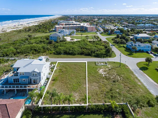 an aerial view of residential houses with outdoor space and swimming pool