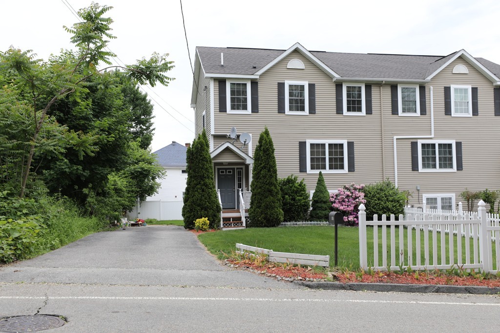 167 Orient Street Worcester, MA 01604 - Photo 1 of 29 a front view of a house with a yard and flower plants